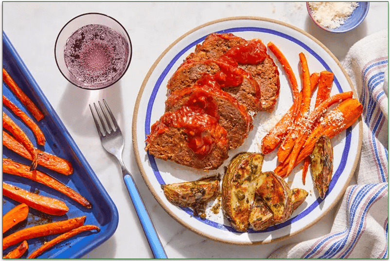 Tasty meatloaf with carrots and a tomato sauce across the top