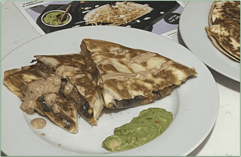 Photo of Home Chef's Southwest-Style Vegetable Quesadilla prepared and plated next to the recipe card