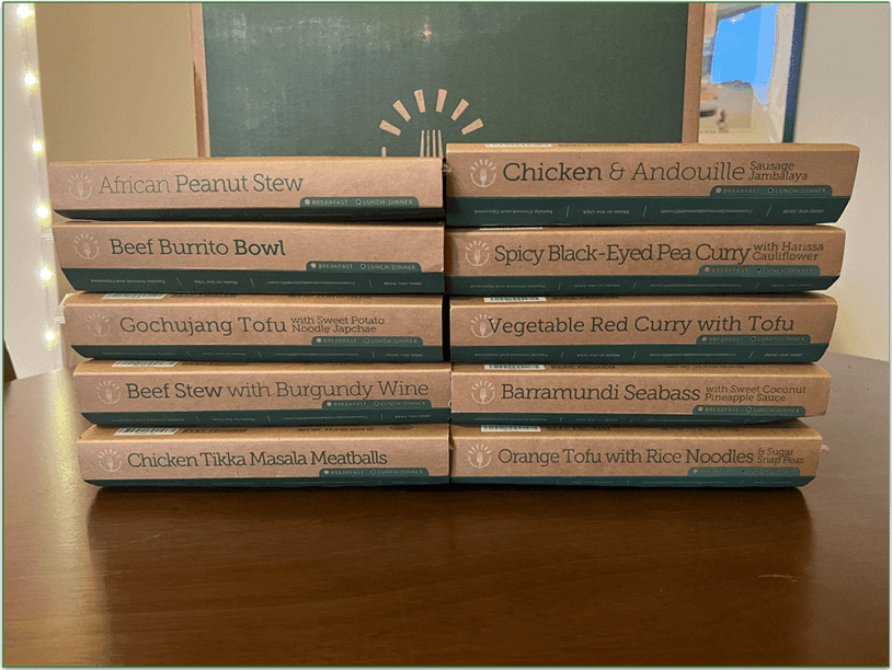 BistroMD meals piled up with the name of the ish clearly visible on the side. BistroMD box in background