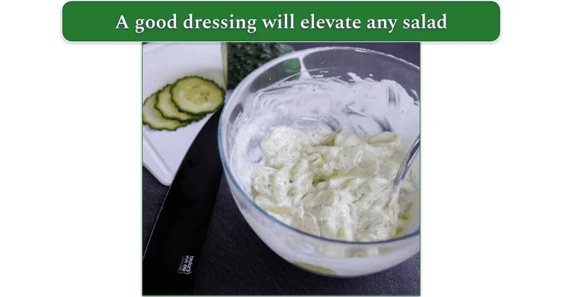 A creamy cucumber salad dressing being mixed in a bowl
