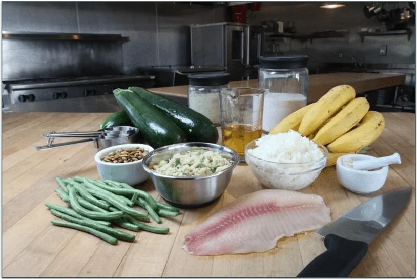 A JustFoodForDogs meal surrounded by raw, fresh ingredients