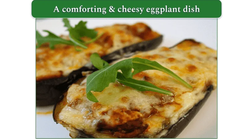 Cheesy baked eggplant topped with rocket leaves