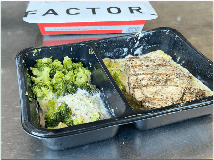 Image of a Factor meal of Black pepper and sage pork chops heated in the microwave safe tray