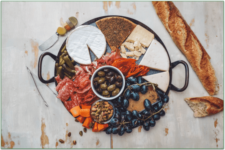 Charcuterie board featuring brie