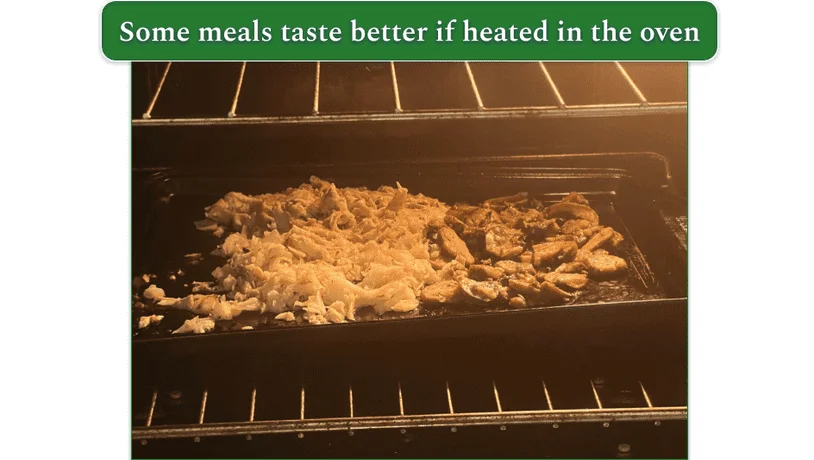 Factor’s dijon cream chicken thighs with garlic cabbage and herb roasted mushrooms spread onto a baking tray in an oven