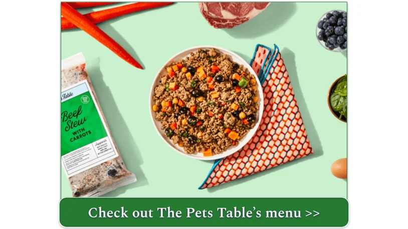 Image of The Pets Table's Beef Stew with Carrots surrounded by fresh ingredients and the packaging
