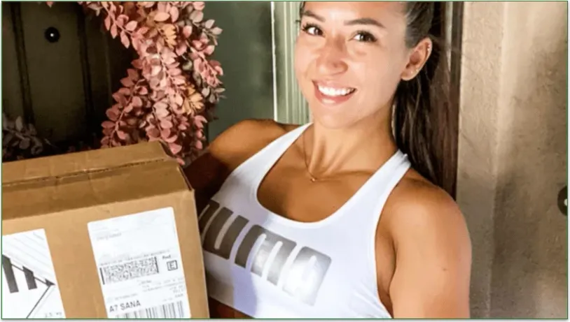 Woman holding an Icon Meals delivery box