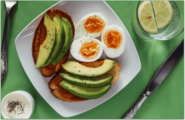 Toasted bread with avocado slices and hard-boiled eggs