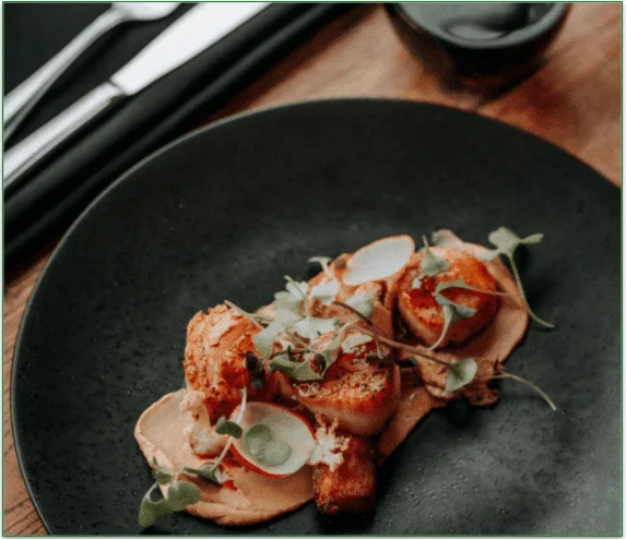 Seared scallops on a plate, waiting for the caviar