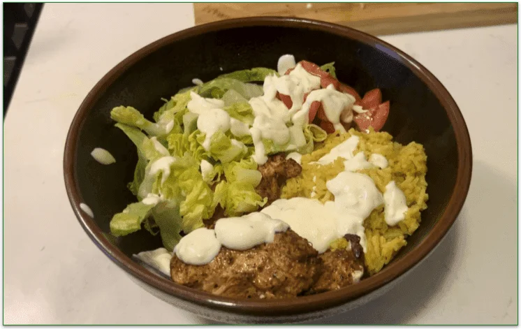 Dinnerly's Halal Cart-Style Chicken over rice in a bowl