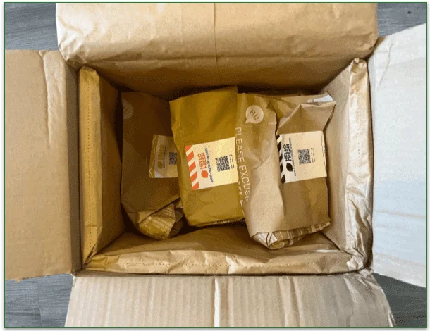 The inside of a HelloFresh box with recipe bags and recyclable insulation