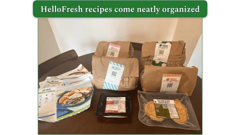 Four paper bags, each containing a different HelloFresh meal kit