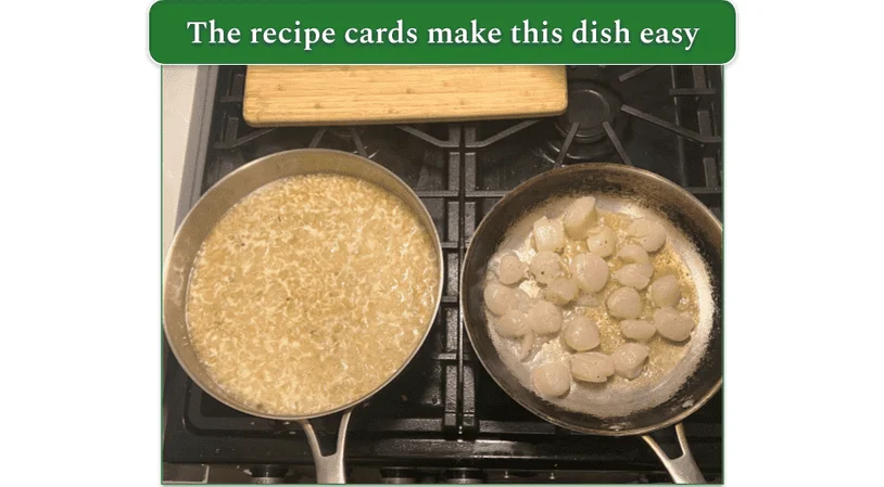 Seared scallops and garlic herb risotto being prepared by our reviewer