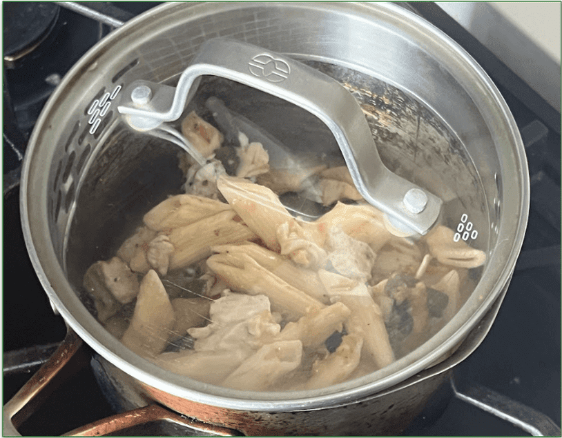 image of a pasta-based dish being heated in a pan on the stove