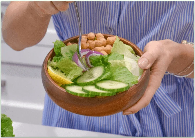 A small bowl filled with different veggies and beans
