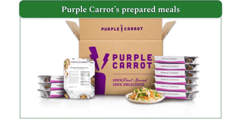 Image of a Purple Carrot delivery box with prepared meals stacked at the side