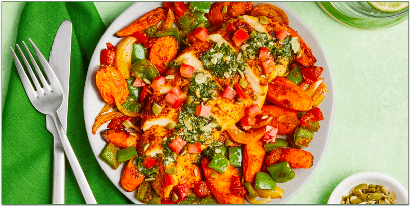 a colorful plate of chicken and vegetables
