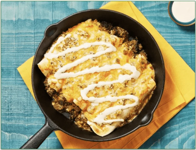 One-Pan Beef Enchiladas Verdes with Mexican Cheese Blend & Hot Sauce Crema by HelloFresh