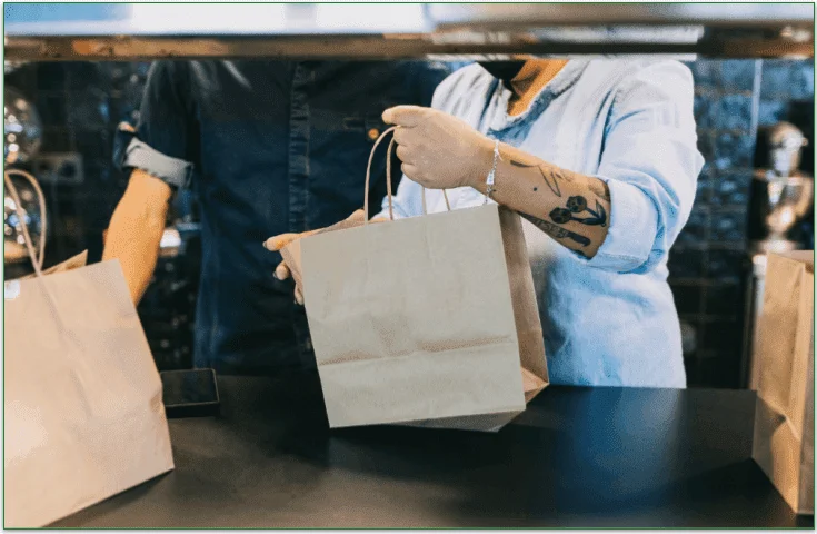  A person holding a takeout bag