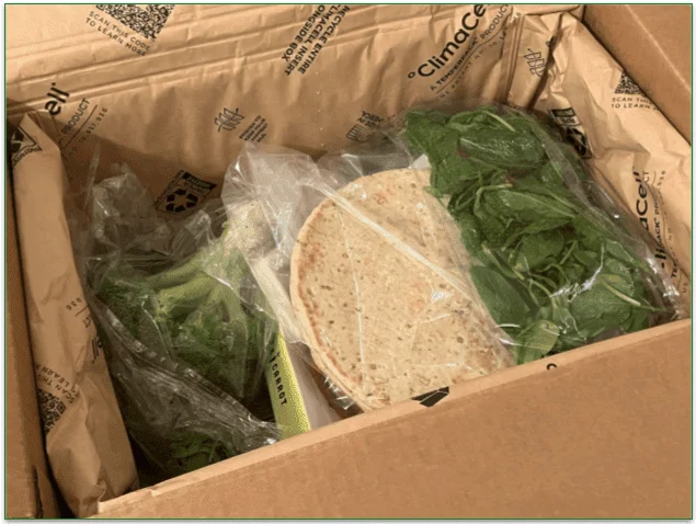 Open Purple Carrot box with ingredients