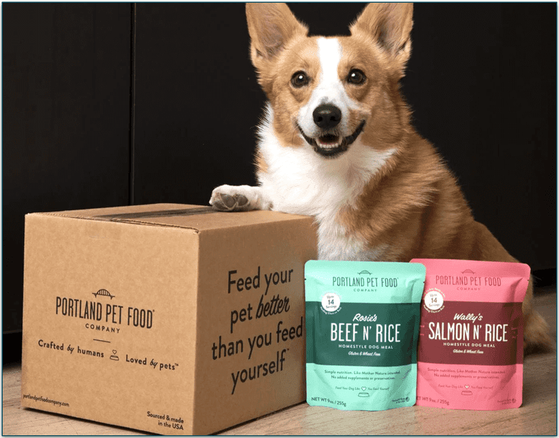 Dog sitting next to a Portland Pet Food delivery box and shelf-stable food packs