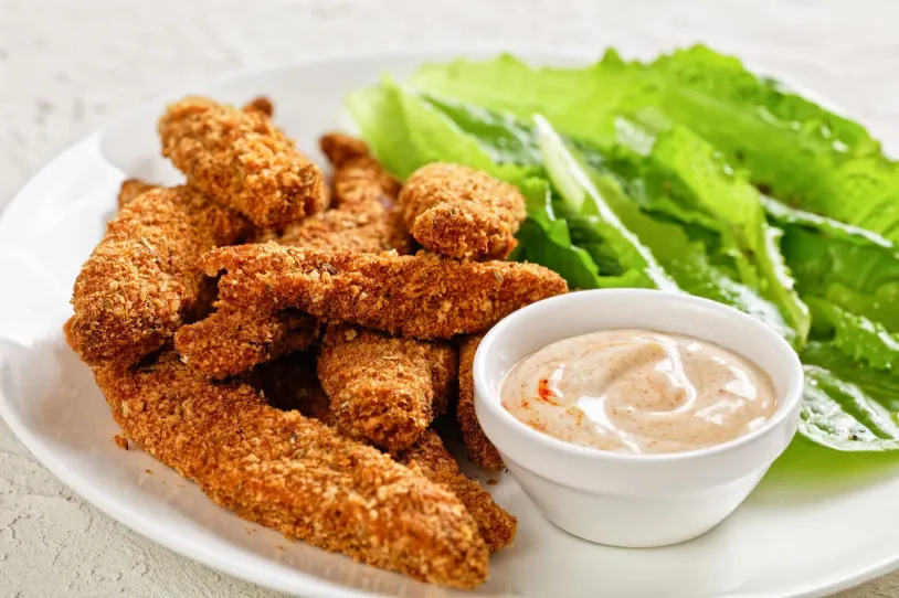 Chicken tenders on a plate with lettuce and chilli mayo