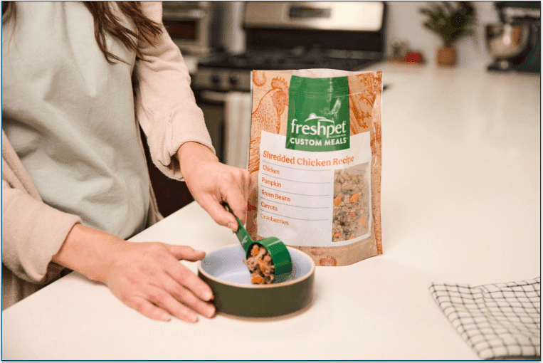 Freshpet meal being poured into a bow and a Freshpet meal sliced in a bowl