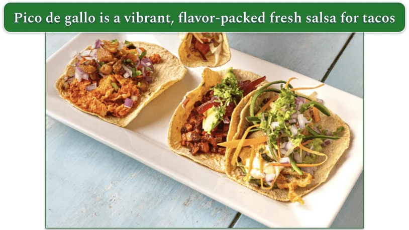 A few tacos on a plate with pico de gallo.