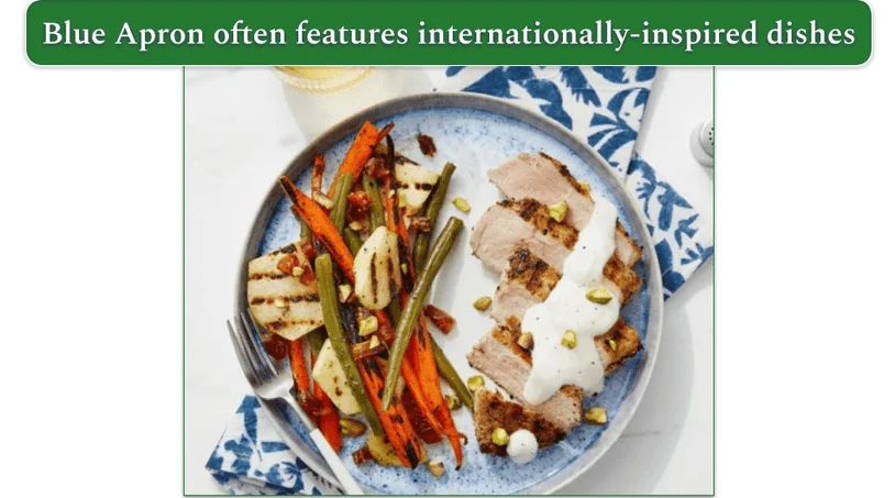 A plate of pork chops with vegetables