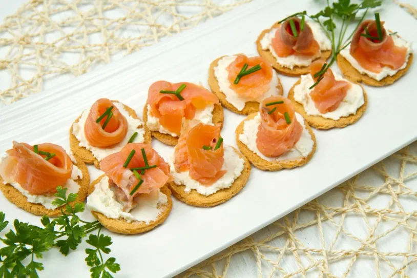 Salmon and cream cheese crackers on a plate