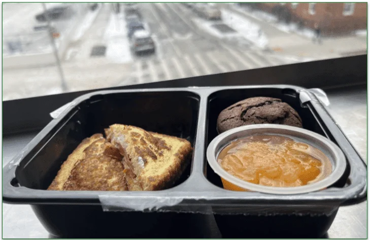 The Kelly grilled sandwich, mandarin slices, and a brownie in a microwaveable tray