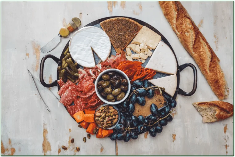 Charcuterie board featuring brie