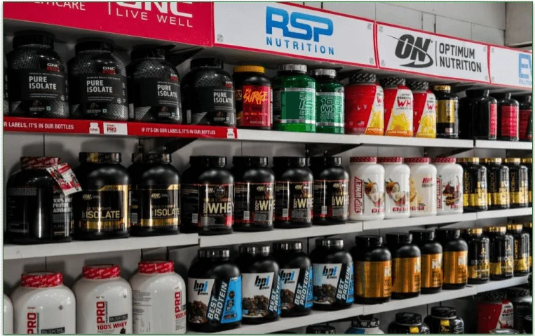 Tubs of different protein powders on a shelf