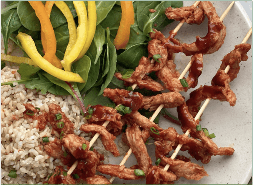 MamaSezz's BBQ protein strips on a plate with rice and salad
