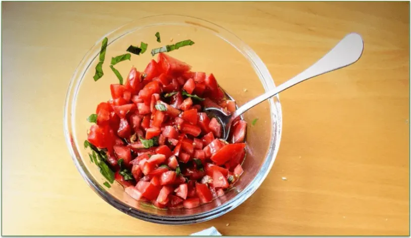 Bowl of Pico de Gallo with a spoon