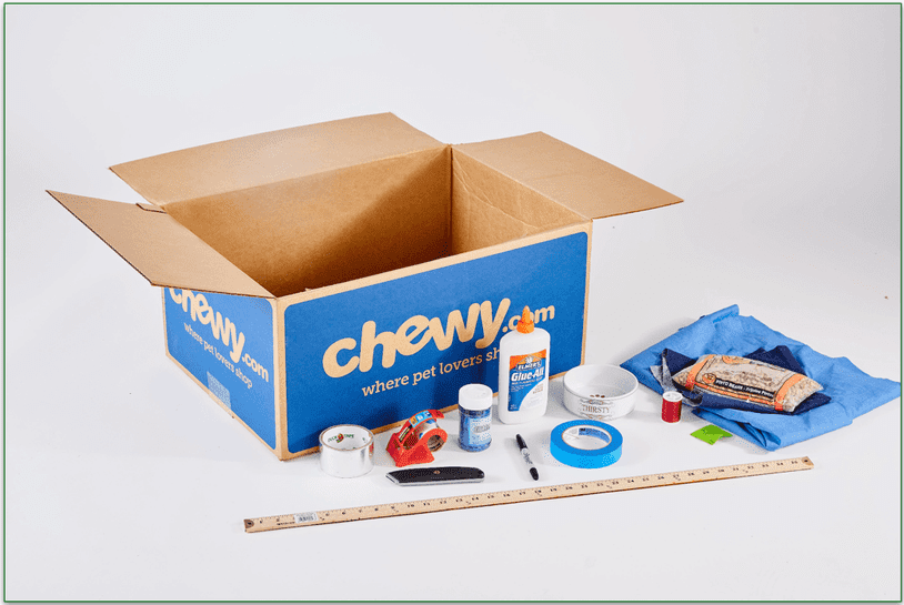 Image of a Chewy cardboard box surrounded by crafting materials
