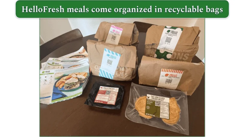 HelloFresh recipe cards and paper bagged ingredients on a table