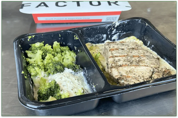 Photo of the Black Pepper & Sage Pork Chop in a microwaveable tray in front of the Factor cardboard sleeve