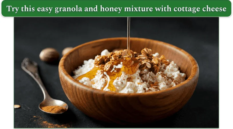 a wooden bowl filled with cottage cheese, topped with Honey, Cinnamon, Crunchy Granola, and Nutmeg