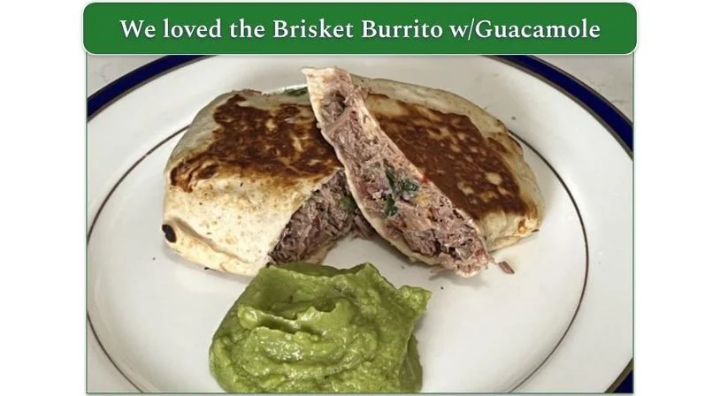 Trifecta's Brisket Burrito on a plate with guacamole