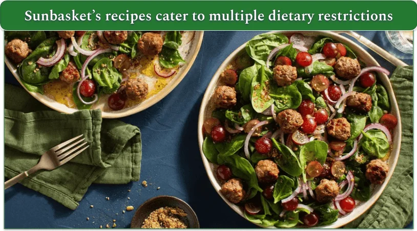 bowl of spinach-grape salad with meatballs