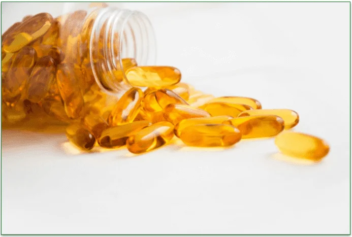 A bunch of omega-6 supplement pills spilling out of a bottle.