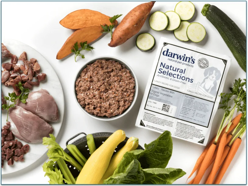 Image if a pack of Darwin's Natural Selections Turkey recipe alongside all the fresh vegetables and meat used in the recipe