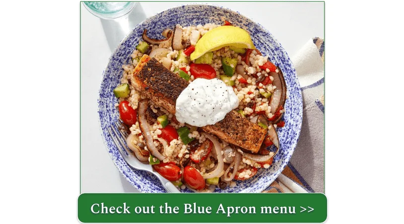 A plate of salmon with a dollop of labneh atop couscous and tomatoes