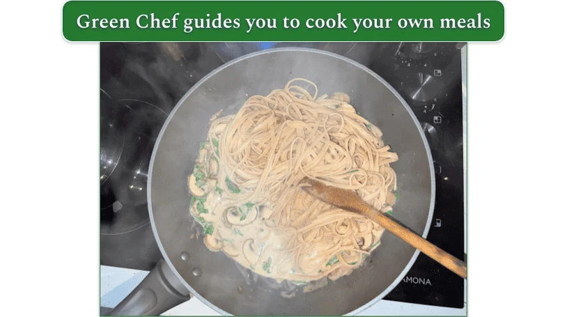 Veggies, sauce, and pasta being combined in a saucepan