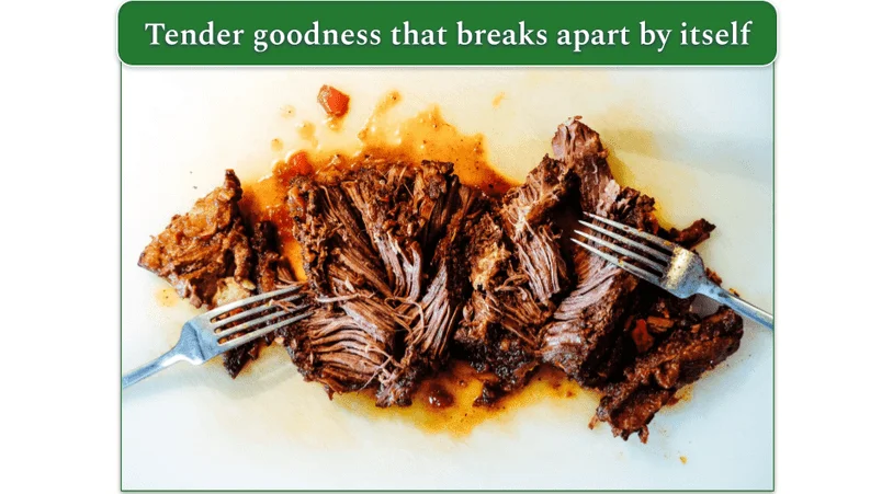 A piece of chuck roast that breaks apart easily, with 2 forks
