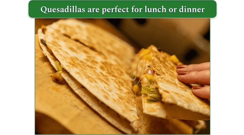 Quesadillas being picked up from a serving board
