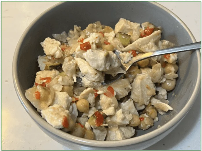 Tempo's Greek-Style Chicken Orzo Bowl served in a bowl with a spoon