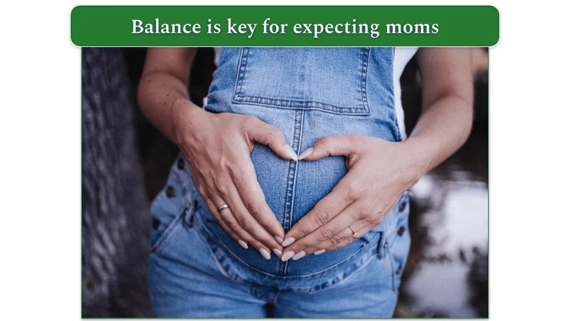 Pregnant woman with hands in a heart shape over bump