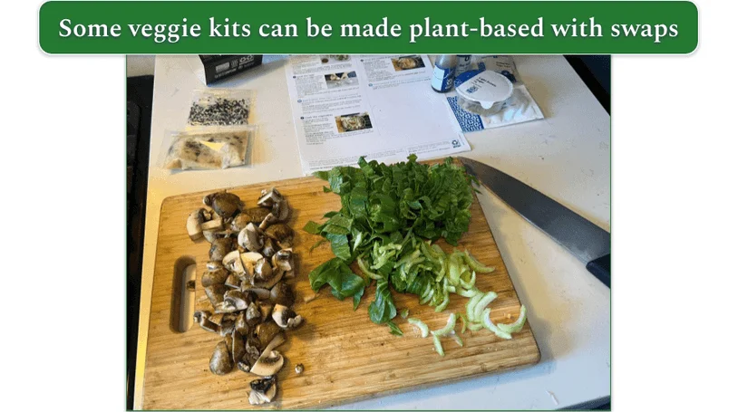 A chopping board with mushrooms and chopped greens